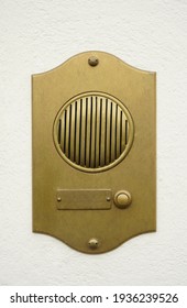 Old Bronze Door Intercom Buzzer. Vintage Golden Buzzer On A White Concrete  Wall