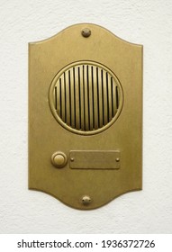 Old Bronze Door Intercom Buzzer. Vintage Golden Buzzer On A White Concrete  Wall