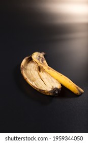 Old Brown Banana Peel Close Up, On Black Background.