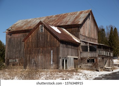 old brown barn with wood siding and metal roof