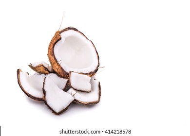 Old brown organic coconut fruit copra broken into pieces on white background
