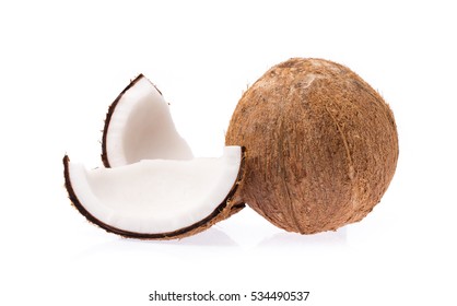 Old brown organic coconut fruit copra broken into pieces and stacked on white background