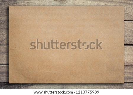 Old brown paper on grunge wood ackground and texture with space.