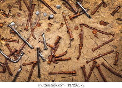 Old brown rusted and new nails in an ancient trunk