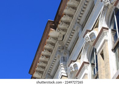 Old building facade against deep blue sky