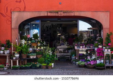 Old Building In France. Entrance Into A Small Flower Shop. Small Local Flower Shop With Beautiful Outside Display.