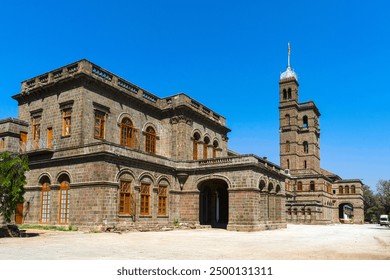 Old building of Pune University under blue skies.  - Powered by Shutterstock