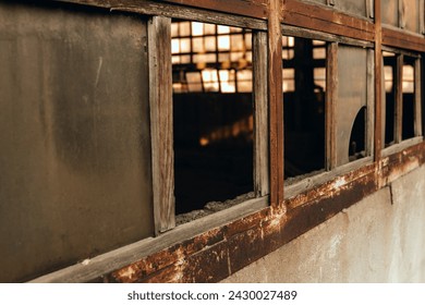 Old building with rusty frames and broken windows.