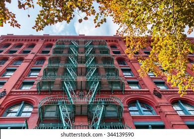 Old Building In Soho, Manhattan, NYC, With Typical Fire Escape Stairs 