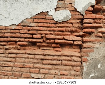 An old building whose bricks are starting to crumble.