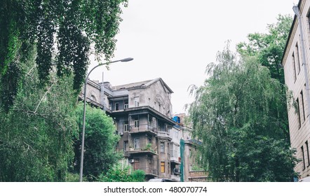 Old buildings facade on sky and green tree background in Kyiv, Ukraine. 