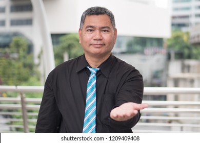 Old Business Man Pointing Up At You, Job Recruit Concept; Portrait Of Confident, Successful Asian Business Man Pointing Finger Or Pointing Hand At Camera; 50s Old South East Asian Man Model