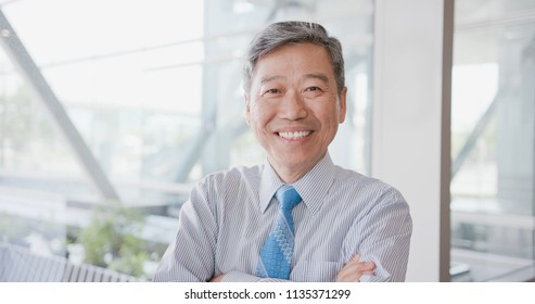old businessman look you and smile happily