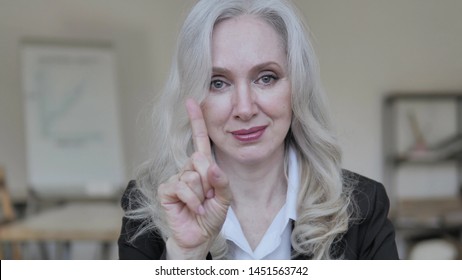 Old Businesswoman Rejecting Offer By Waving Finger