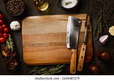 Old Butcher Cooking Tools On Cutting Board. Dark Concrete With Spices Salt And Pepper Flat Lay