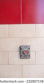 Old button on tile wall