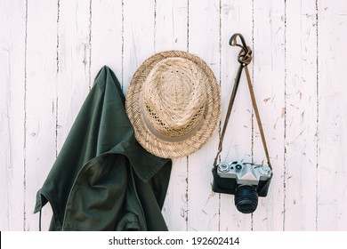 Old Camera And Clothes Hanging On A Wall.