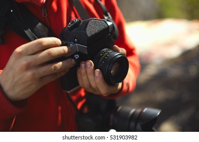 Old camera in the hands of the photographer. - Shutterstock ID 531903982