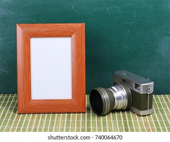 Old Camera And Picture Frame On Desk, Chalkboard Background