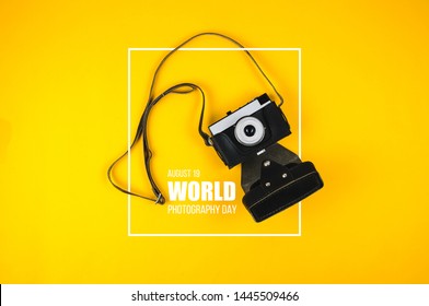 Old camera and text "World photography day" on yellow background - Shutterstock ID 1445509466