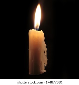 Old Candle On The Black Background 