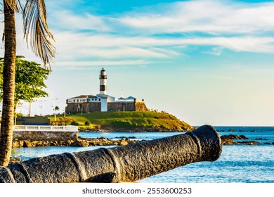 Old cannon and the Barra Lighthouse in the city of Salvador in Bahia surrounded by the sea - Powered by Shutterstock