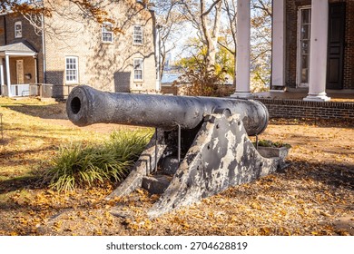 An old cannon sits in front of the Commanding Officer's Quarter's on Governor's Island in New York. 