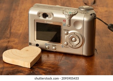 Old Canon Camera On A Wooden Background. Old Digital Camera. 