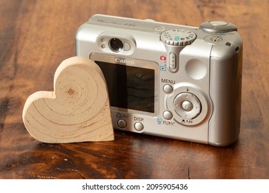 Old Canon Camera On A Wooden Background. Old Digital Camera. 