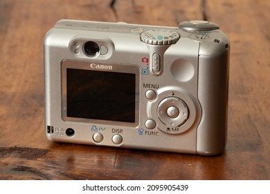 Old Canon Camera On A Wooden Background. Old Digital Camera. 