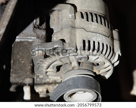 Old car alternator with unstrung belt close up, motor service repair