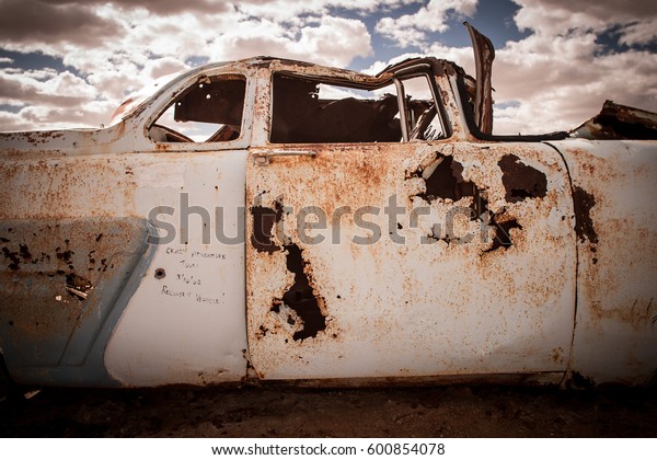 Old car body rusting in\
the outback