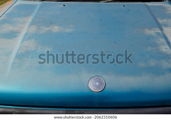 old car bonnet engine hood\
green used paint worn by time season and sun faded grunge on front\
vehicle