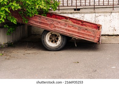 An Old Car Cargo Trailer For A Passenger Car Parked Next To The House