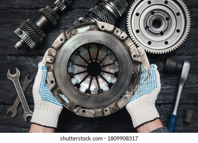 Old car clutch basket in car service worker hands close up on black table background. - Shutterstock ID 1809908317