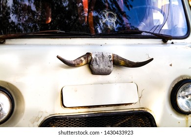 Old Car With Cow Horns On The Cab