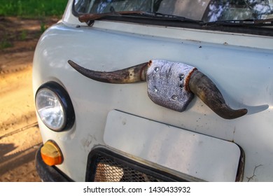 Old Car With Cow Horns On The Cab