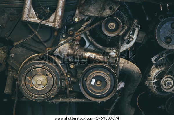 old car engine\
spare part used closeup Serpentine belt vehicle machine dirty\
grease grunge with oil in\
garage.