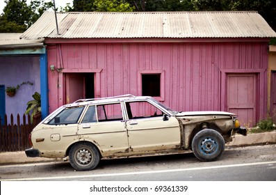 Old Car In Front Of Pink Building