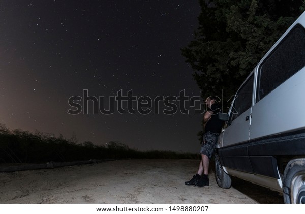 old car image in summer night with full
lenght portrait man near broken down car at
night