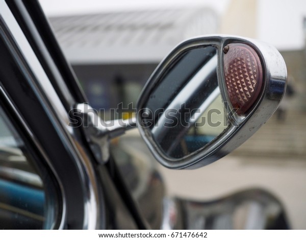 Old\
car mirror with turn indicator installed on the\
door