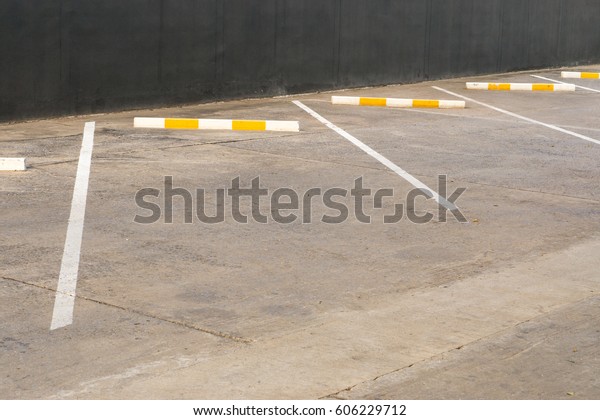 Old\
Car parking lot with white mark., Empty parking lot marked with\
white lines., Yellow line in the parking lot\
outdoor