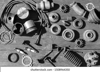 Old Car Parts On A Wooden Table. View From Above.