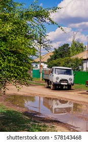old car in a puddle reflection