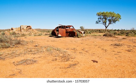 An Old Car Rusts Away In The Desert In The Australian Outback