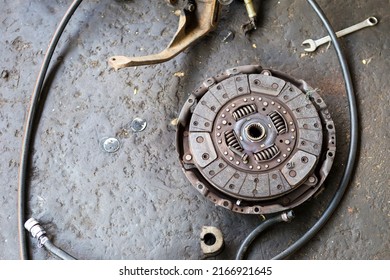 Old Car Spare Part On Dirty Garage Floor, Damaged Car Spare Part