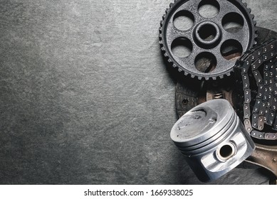 Old Car Spare Parts On Gray Background With Copy Space.