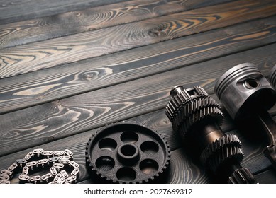 Old car spare parts on the wooden workbench background with copy space.