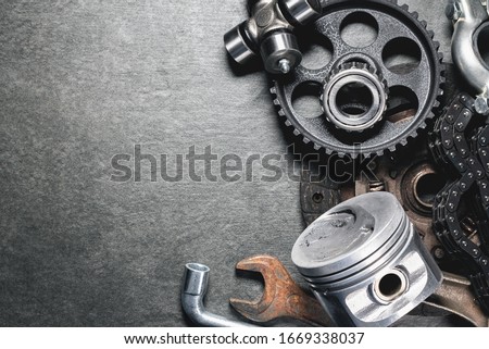Old car spare parts on gray background with copy space.