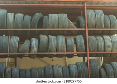 Old Car Tires Under The Roof. Warehouse Of An Old Tire Garage. Used Car Tires